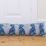 Draught excluder in natural linen with foo dog print: keeps in heat. Designed by Curious Lions and made in the UK. Washable cover and pad.